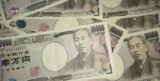 Japan Holds Record Low Interest Rates, Yen Falls
